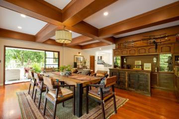 Spacious dining room with hardwood floors and exposed wooden beams