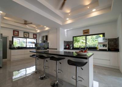 Modern spacious kitchen with breakfast bar and high stools