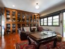Spacious living room with hardwood floors and large bookshelf