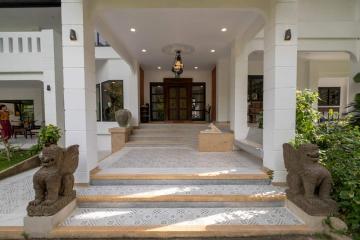 Elegant entrance of a building with steps and decorative sculptures