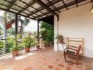 Spacious covered patio with terracotta flooring and garden view