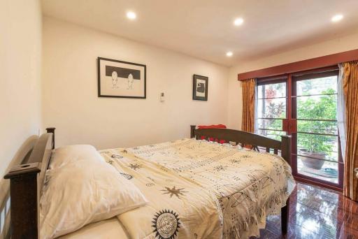Well-lit cozy bedroom with garden view