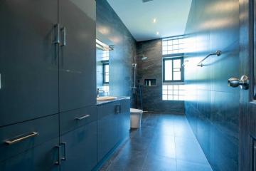 Modern bathroom with blue tiles and spacious design