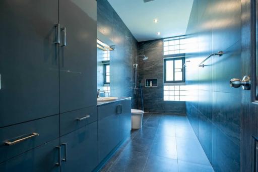 Modern bathroom with blue tiles and spacious design