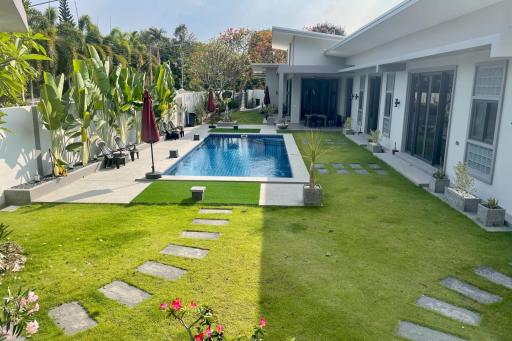 Spacious backyard with pool and lush garden