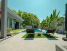 Modern house with pool and lounge chairs in the backyard