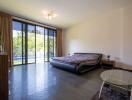 Spacious bedroom with direct access to pool view through sliding glass doors