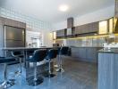 Modern kitchen with breakfast bar and integrated appliances