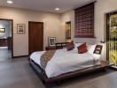 Spacious bedroom with modern design, adjoining living space and outdoor access
