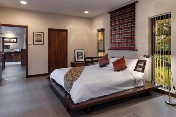 Spacious bedroom with modern design, adjoining living space and outdoor access