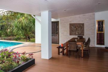 Spacious patio with dining area and swimming pool