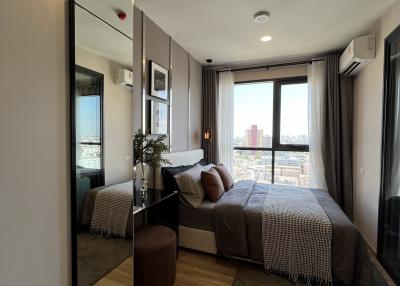 Modern bedroom with large window and city view