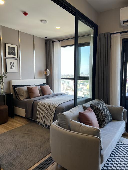 Modern bedroom with queen-size bed and city view