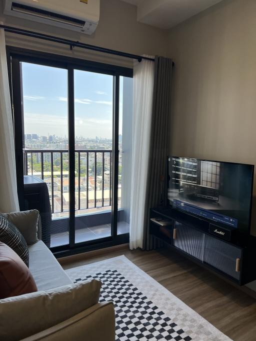 Cozy living room with large window and city view