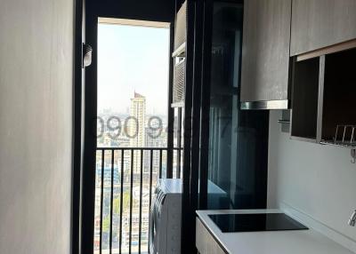 Compact modern kitchen with balcony access and city view