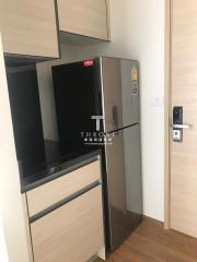 Modern kitchen with stainless steel refrigerator and wooden cabinetry