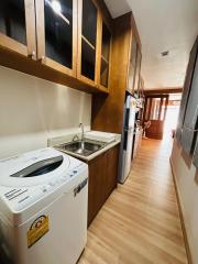 Compact modern kitchen with wooden cabinets and state-of-the-art appliances