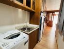 Compact modern kitchen with wooden cabinets and state-of-the-art appliances