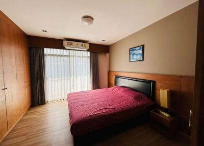 Cozy bedroom with wooden furnishings and natural light