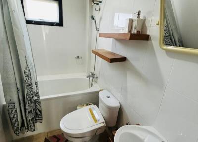 Clean and modern bathroom with shower curtain and wooden shelves