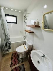 Clean and modern bathroom with shower curtain and wooden shelves