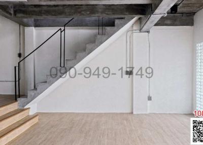 Modern interior with concrete staircase and wooden flooring