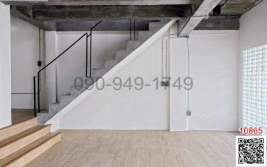 Modern interior with concrete staircase and wooden flooring