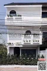 Modern three-story building with abundant window planters