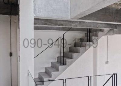 Modern interior with concrete staircase and glass balustrades