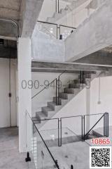 Modern interior with concrete staircase and glass balustrades