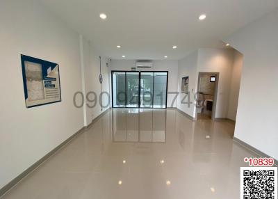 Spacious and well-lit living room with glossy floor tiles and modern design