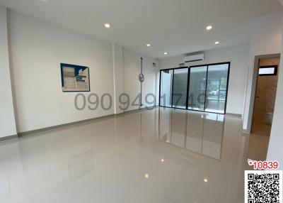 Spacious and well-lit living room with glossy tiled flooring and large sliding glass doors