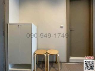 Modern entryway with a white cabinet and two stools