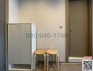 Modern entryway with a white cabinet and two stools