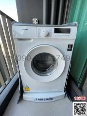 Samsung washing machine on a balcony with glass railing