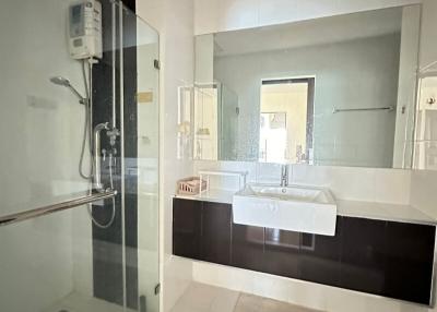 Modern bathroom with glass shower and dual sink vanity