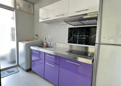 Modern kitchen with purple cabinets and stainless steel appliances