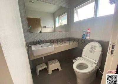 Modern bathroom with window and tiled walls