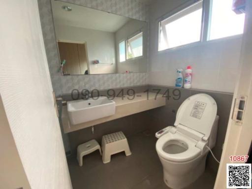 Modern bathroom with window and tiled walls