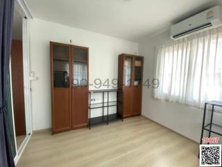Bright bedroom with air conditioning and wooden furniture