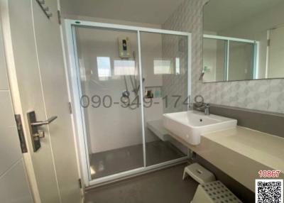 Modern bathroom with glass shower and mirrored cabinet