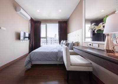 Modern bedroom with large window and city view