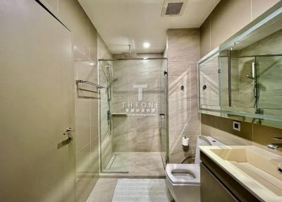 Modern bathroom interior with glass shower stall and elegant fixtures