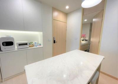 Modern kitchen interior with marble countertop and white cabinetry