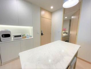 Modern kitchen interior with marble countertop and white cabinetry