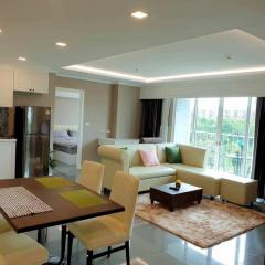 Modern living room with open floor plan including dining area and partial view of the kitchen