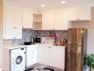 Modern kitchen with stainless steel appliances and white cabinetry