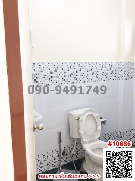 Compact bathroom with white tiles and toilet