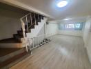 Spacious interior room with staircase and laminate flooring
