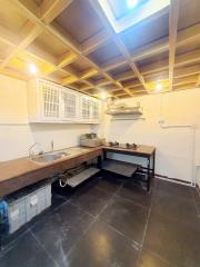 Compact kitchen with wooden countertops and skylight